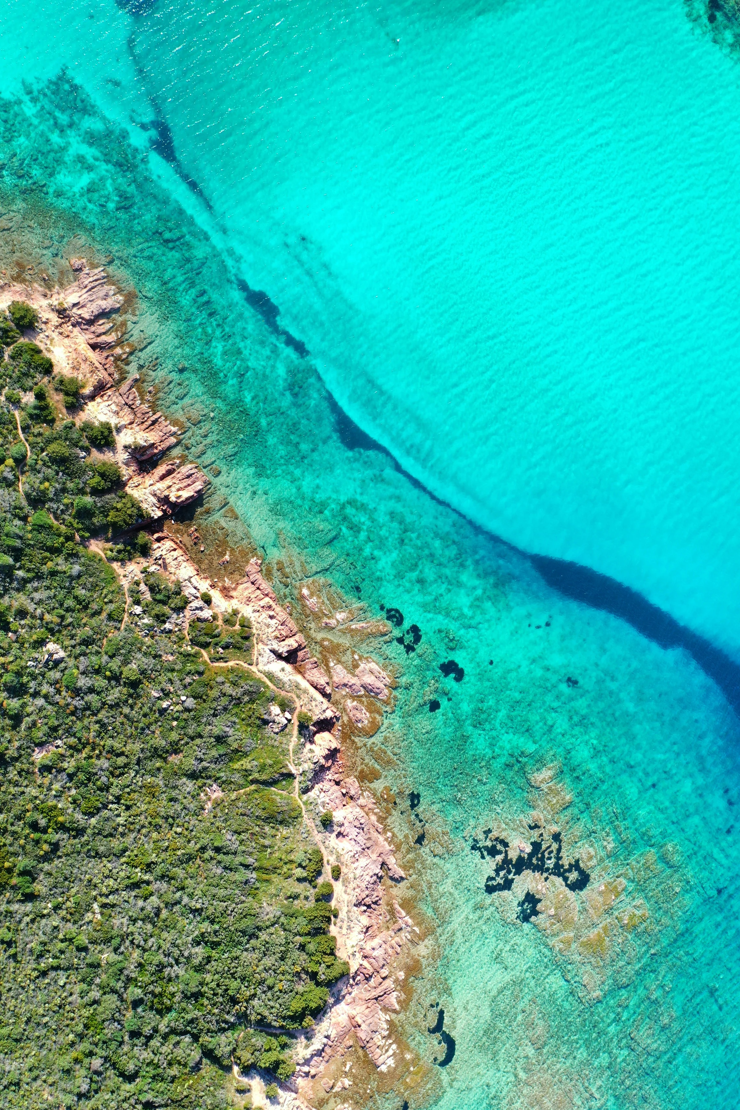 Granite shoreline and turquoise water at Porto San Paolo, Sardinia